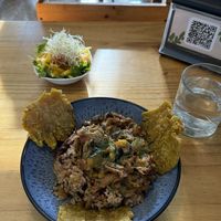 Rice and beans, mixed with seitan, mushrooms, and veggies, with tostones as a nice addition and served with a refreshing mango salad   at Arbol de Seda in San Jose