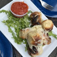 Garlic knots with vegan cheese  at Flying Saucer Pizza Company in Salem