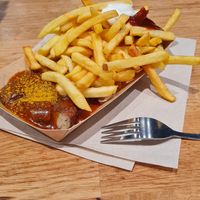 Vegan currywurst with fries at Pommes Freunde - OEZ in Munich