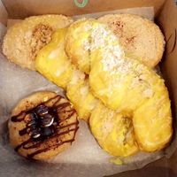 Apple crumb donut, raspberry cheesecake donut, s’mores donut, and 2 lemon twists  at The Cinnamon Snail in New York City