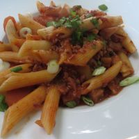 Kostbar Penne with fried Mediterranean vegetables, rocket leaves and hot tomato sauce at Restaurant Café Kostbar in Saarbrucken