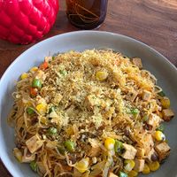 Corn noodles with veggies, tofu and lentils topped with nutritional yeast at O Baba Vegan in Denpasar