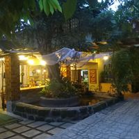behind the tree are the "indoor" tables at Satya Graha in Los Banos