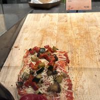 Vegan pizza. 12.50 euro. With plant-based cheese  at AMS - The Oven  in Schiphol