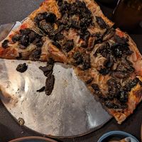Mushroom, olive, and onion vegan pizza at El Gaita Pizza Bar in El Calafate