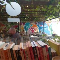 Inside with plenty of books 📚 and seating outside at Zrno Bio Bistro in Zagreb