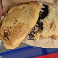 Empanada with vegetables to the left and spinach to the right. at M-Panada  in Zurich