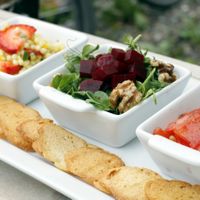 Three salads: Israeli couscous with strawberries, beets with greens and walnuts, and tomatoes with pinenuts.  Served with toasted baguette drizzled in olive oil. at Eddyline Bistro Cafe in Smithers