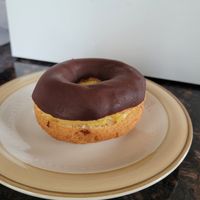 Lydia's Eclair: cake donut, chocolate glaze, homemade pastry cream sandwiched between at Liberation Kitchen in Chicago