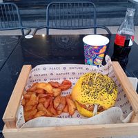 Crispy burger with wedges and drink at Flower Burger in Padua