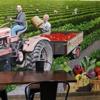 Cute mural inside featuring the owner and his son harvesting tomatoes. at Crepes Bistro in Santa Clara
