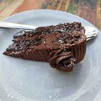 A rich chocolate sponge cake layered with 
smooth chocolate fudge, made using 
dairy free alternative ingredients at Sano in Glasgow