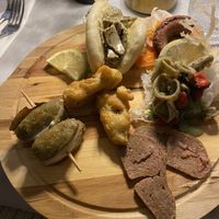 Tagliere di pesce con bao di alici marinate, insalata di polpo, calamari e cozze, pesce spada affumicato, baccalà fritto, involtini di pesce spada alla palermitana  at In Cottura - Home Vegan Restaurant in Palermo