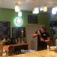 Barista putting some chocolate syrup in my cup at The Green Bean Coffee Shop in Yerevan