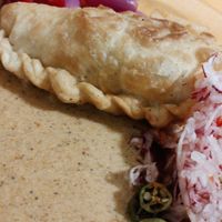 Peanut sauce with chile, radish, and empanada at Raul in Cochabamba