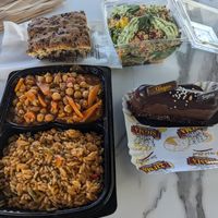 Pre-made salad, vegan dessert, olive bread and combo from vegan hot foods counter at Sigma Bakeries in Ayia Napa