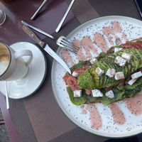 Latte with almond milk and avocado toast with feta  at Eathica Eatery in Ankara