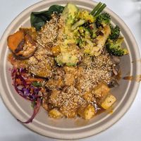 Spicy harvest bowl $18.50 Little collins location (roast tofu, mushrooms, spinach, slaw, sweet potato, avo, brown rice, broccoli, w/spicy peanut dressing): DELICIOUS and health at Greenstreat in Melbourne
