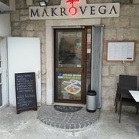 Outside of restaurant with daily menu shown. at Makro Vega in Split