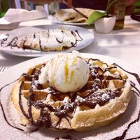 Vegan waffle & ice cream with vegan crepes in the background! at Creperie Lamara in Hannover