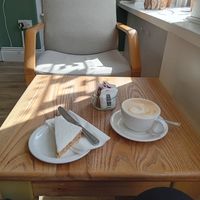 Lemon coconut cake labeled vegan, with oat latte at Giraffe Cafe in Perth