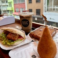 Vegan Tofu burger, cappuccino with plant based milk and vegan cozinha.   at 89ºC Coffee Station in Sao Paulo