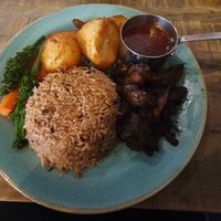 Vegan Sunday Roast - Jerk Mushroom (Ask your server for todays flavour) seasonal veg, garlic roast potatoes, rice & peas, fried plantain & our signature homemade veggie gravy. at Jerk Junction Wilmslow in Wilmslow