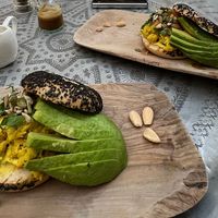 Home made from chickpeas milk, turmeric, spring onions and herbs. Served on a toasted bagel with our home made vegan cheese sauce, tomatoes and avocado  at Comptoir 102 in Dubai