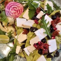 "Greek Avo & Feta" (Zwei Sauerteigbrotscheiben mit Avocado, veganer Feta, Granatapfel, Oliven und mehr) at Café No. 5 in Cologne