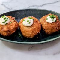 Chorizo Arancini: crumbed risotto fritters, aioli, chipotle ketchup at Mildreds - Victoria in South West London