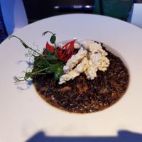 Vegan risotto with black rice and mushrooms at Wonderland Ljubljana in Ljubljana