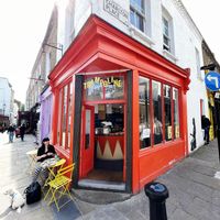 Exterior with outside seating at Trampoline Cafe in North London