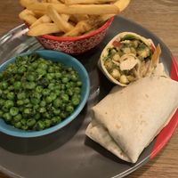 Chips, peas with herbs and chilli and spinach and chickpea wrap  at Nando's - Dundrum Town Centre in Dublin
