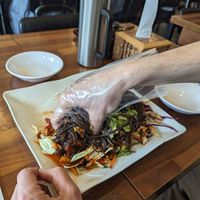 Mixing yourself (and cutting with scissors) at Surinnal Seolleongtang Halmae Jokbal Bossam in Seoul