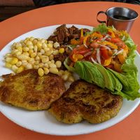 A la carte meal of seitan, corn, salad, and delicious patties (I think it was platano) at Quinua in Quito