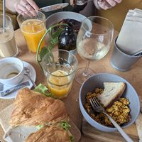 Pancakes, ham & cheese croissant, mexico scrambled tofu, white wine and fresh orange juice at GAL Cafe in Lisbon