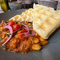 Potato waffles with savoury butter beans and tomato sauce. at Coffee & Plant in Nairobi