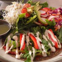 Raw pizza and salad with dressing at Matapoteket in Stockholm