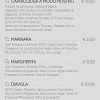 Traditional pizzas including the classic Marinara at Pizzeria da Lioniello   in Milan