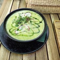 Broccoli and other vegetables cream soup with basil oil on top.   at Soul Kitchen in Sofia