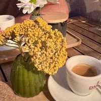 Coffee served with decorative flowers  at Soul Kitchen in Sofia