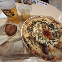 Vegan Teriyaki Soy Meat Pizza and Vegan Freshly Fried Curry bread with pint of Kirin and orange juice. 👏 at HND - Chaya Vegan Friendly Tokyo - T3 in Ota