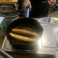 Sausages in the pan getting fried   at Lanna Square Vegan in Chiang Mai