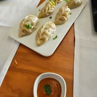 Vegan momos with spicy dipping sauce at Byanjan in Madrid