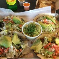 Rajas tacos (left), Vegetarian Crumble tacos (right), side of chips & guacamole. at El Camino Gourmet Tacos in Eagan