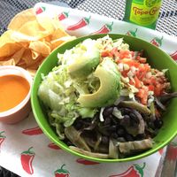Rajas bowl (cactus, peppers, onions, pico, lettuce, avocado, beans, rice). Side of chips & salsa. at El Camino Gourmet Tacos in Eagan