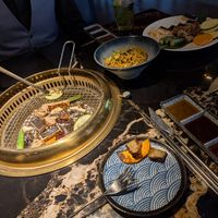 Cooking our own unseasoned food at the table at GUYSHI Bar + BBQ in Sheffield