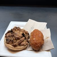 Pizza al taglio (left), supplì (right)  at Fermaggio Bistrot & Store in Rome