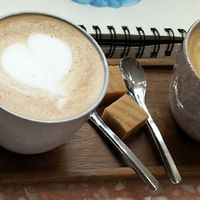 Right: cappuccino with oat milk at FRIDA Book Café in Enschede