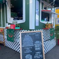 Picture of the menu and corner of cart. Not all menu items are on physical menu (ex: fried pickles).  at The Vegan Phoenix in Beaverton